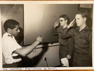 Two soldiers saluting an officer in promotion ceremony