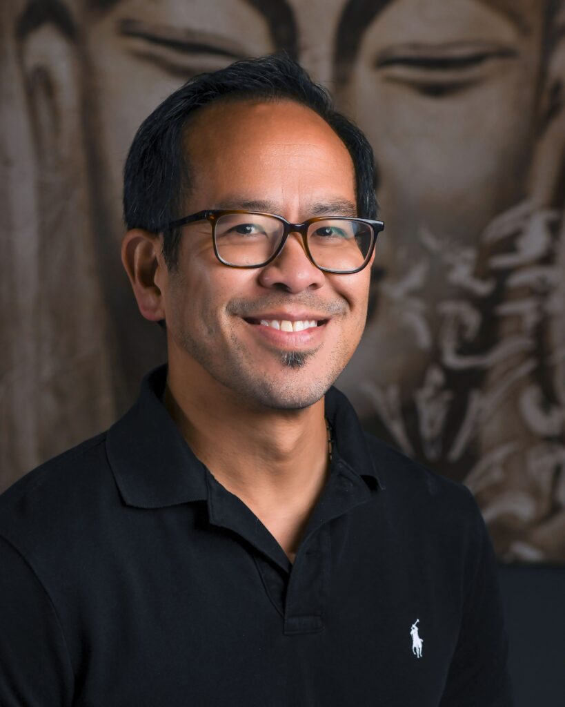 a man wearing glasses and a black shirt