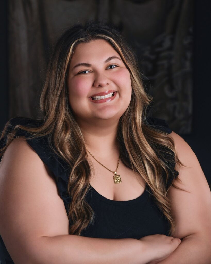 a woman with her arms crossed posing for a picture