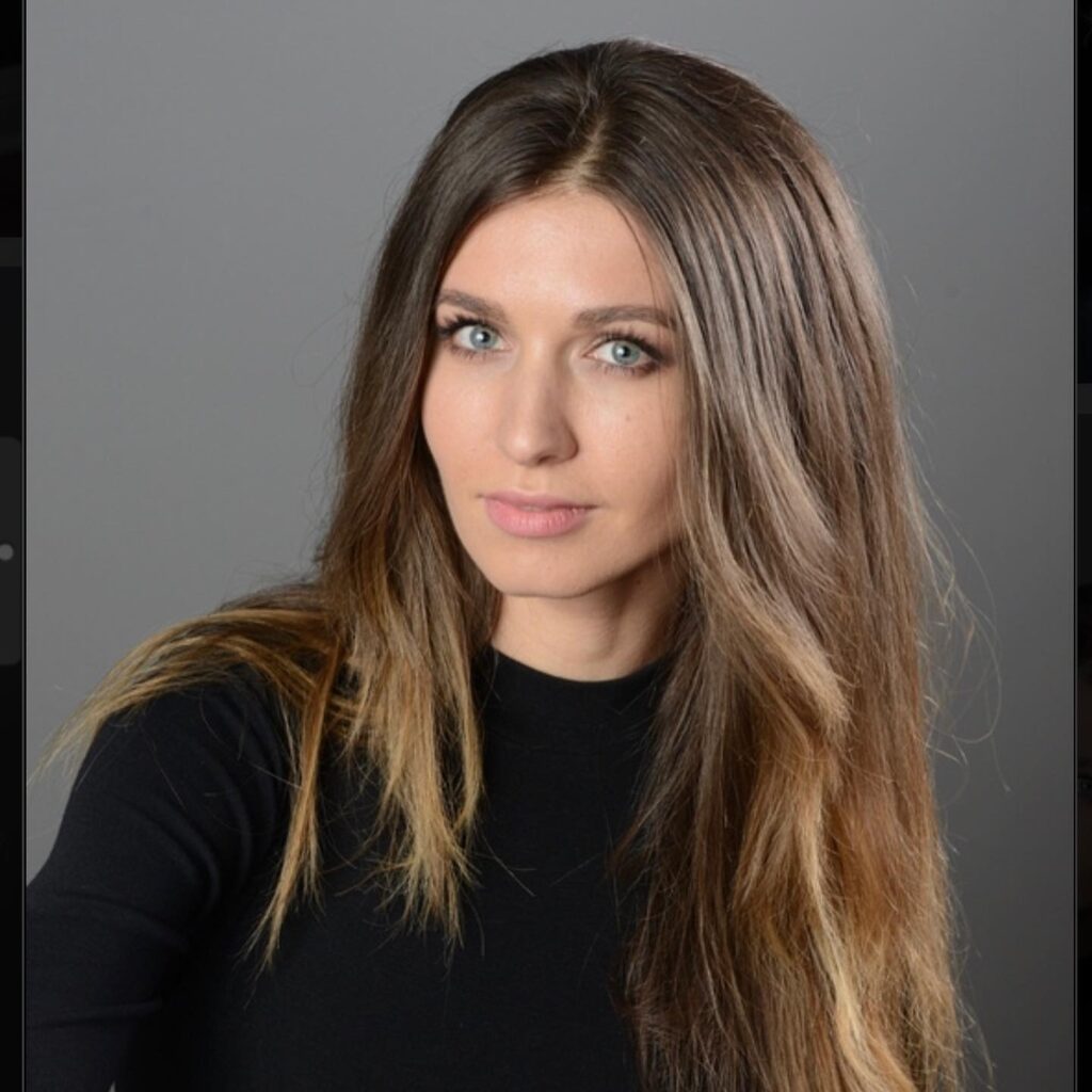 a woman with long hair is posing for a picture