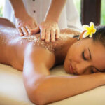 a woman getting a back massage at a spa