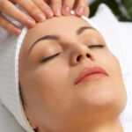 a woman getting a head massage at a spa