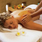 a woman getting a back massage at a spa
