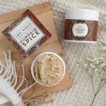 a cup of coffee, a jar of whipped cream and a jar of spice on