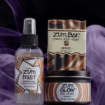 a bottle of zum mist next to a tube of deodorant
