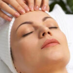 a woman getting a facial massage at a spa