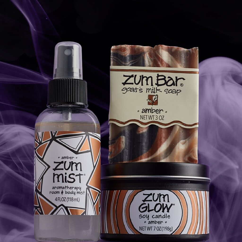 a bottle of zum mist next to a tube of deodorant