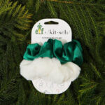 a green and white christmas tree ornament with a bow