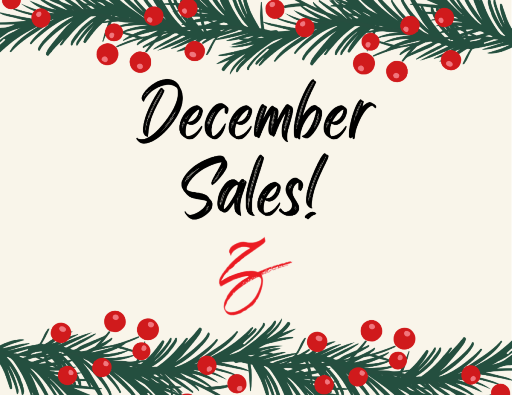 a christmas sale sign with pine branches and berries